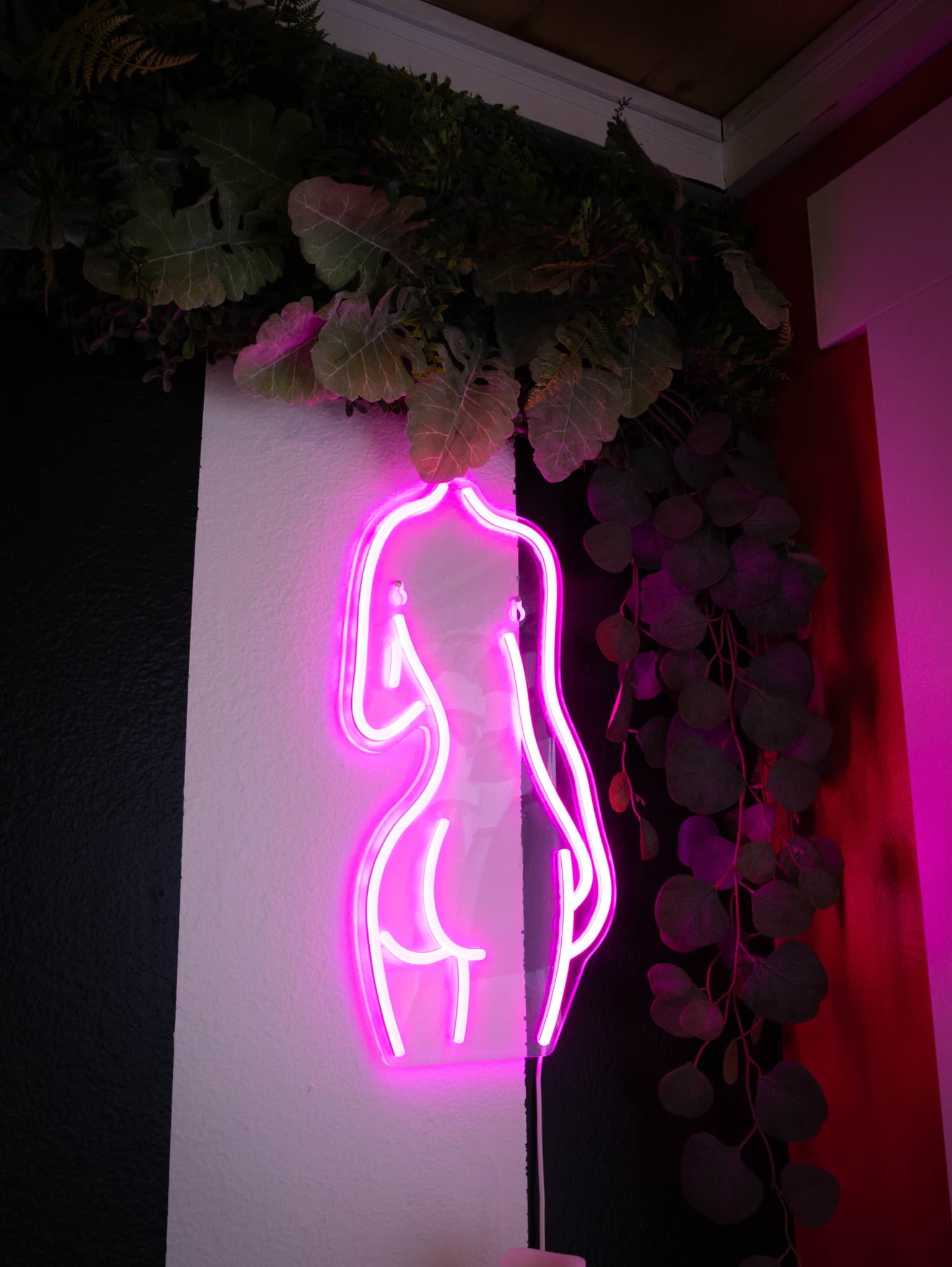 Salon interior with pink neon signs